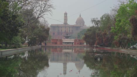 rajpath and central vista lawns renamed as kartavya path in poor air quality, low visibility, grey smog, foggy mist sky with reflection, new delhi, india, asia