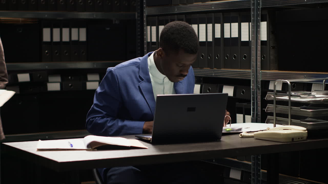 Man working with files and laptop in office