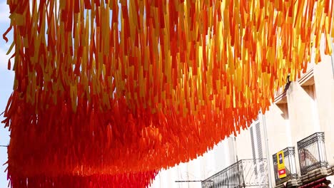 vibrant ribbons hanging in a street in libourne