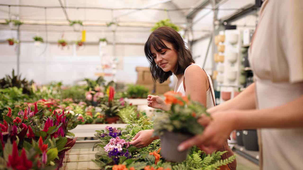 Woman choosing plants in garden center