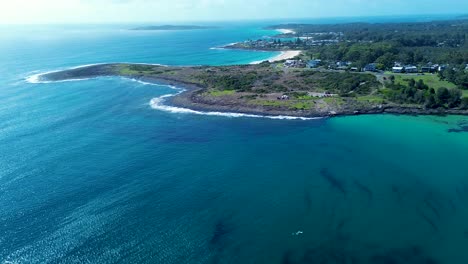 drone aerial landscape of bawley point town coastline headland with sandy beach rocky bay residential homes suburban town shoalhaven australia travel holidays tourism