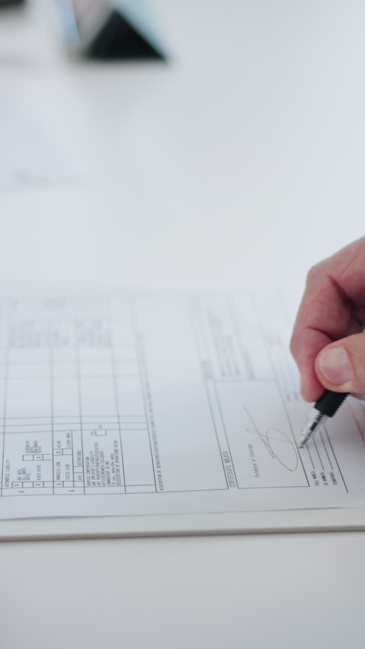 Close-Up of Two People Signing an Official Document