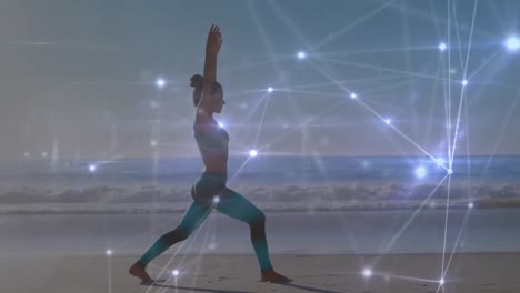 Animation-of-networks-of-connections-over-caucasian-woman-praciticing-yoga-on-beach