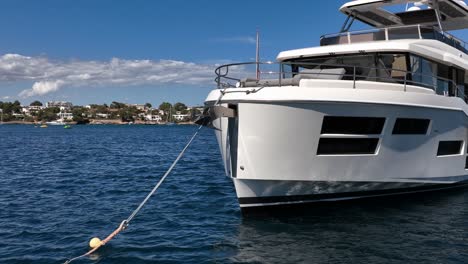 Close-up-of-luxury-yacht-in-calm-bay-in-a-sunny-day-in-slow-motion-by-drone