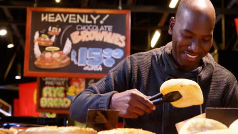 Man-packing-bread-at-bread-counter