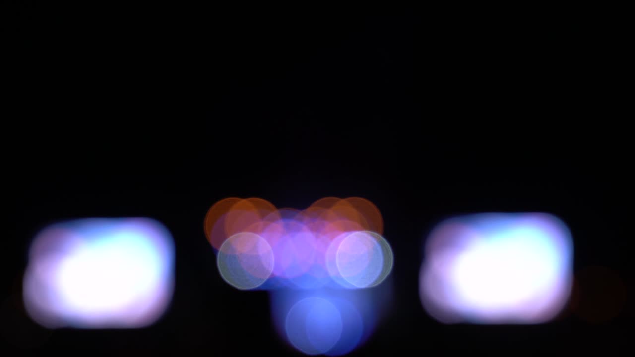 Blurred bokeh traffic on the road at night in a big city,