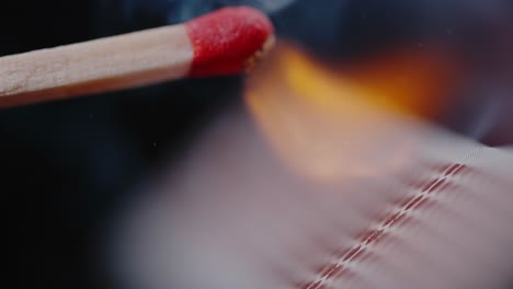 intense flame igniting from struck match on black background