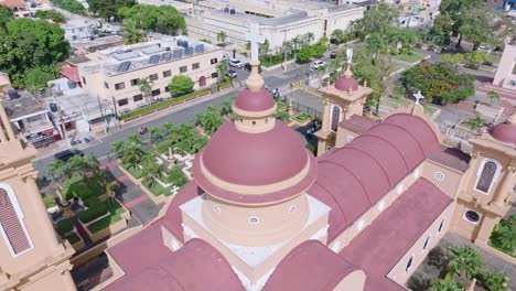 Catholic-cross-on-red-church-roof-in-the-Caribbean-town-San-Cristobal,-aerial