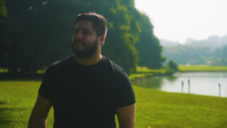 young man walking at a park near the lake enjoying life