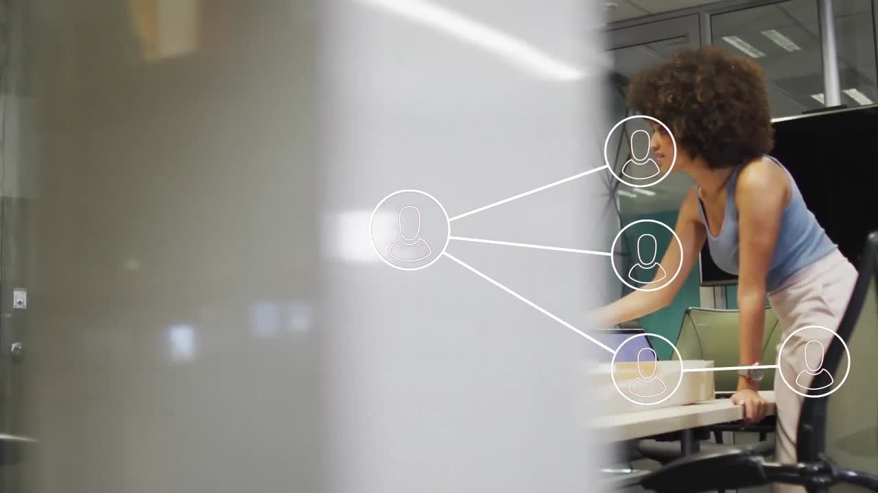 Animation of network of connections with icons over diverse business people working at office