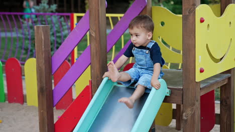 child on playground slide