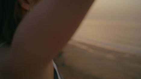 woman meditating on the beach at sunrise/sunset
