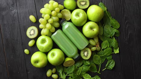 mixed green fruits and vegetables placed on black wooden table