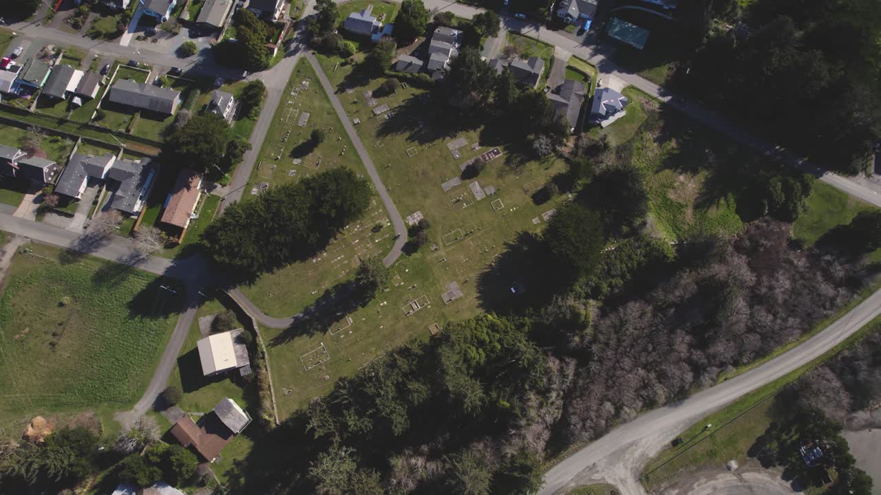 hermosa vista aérea de pájaro de 4k de los suburbios y el cementerio de bandon oregon