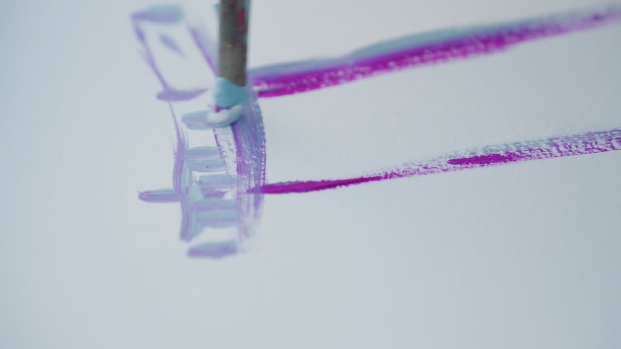 close up brush painting simple house outline on plain white sheet with purple and blue strokes using watercolor palette on wood bench by sunset capturing serene creative art process artistic
