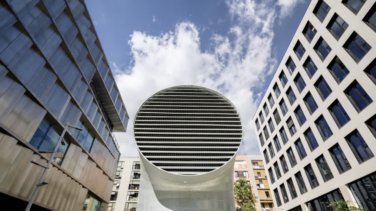 Old factory and industrial complex and air vent with passing clouds