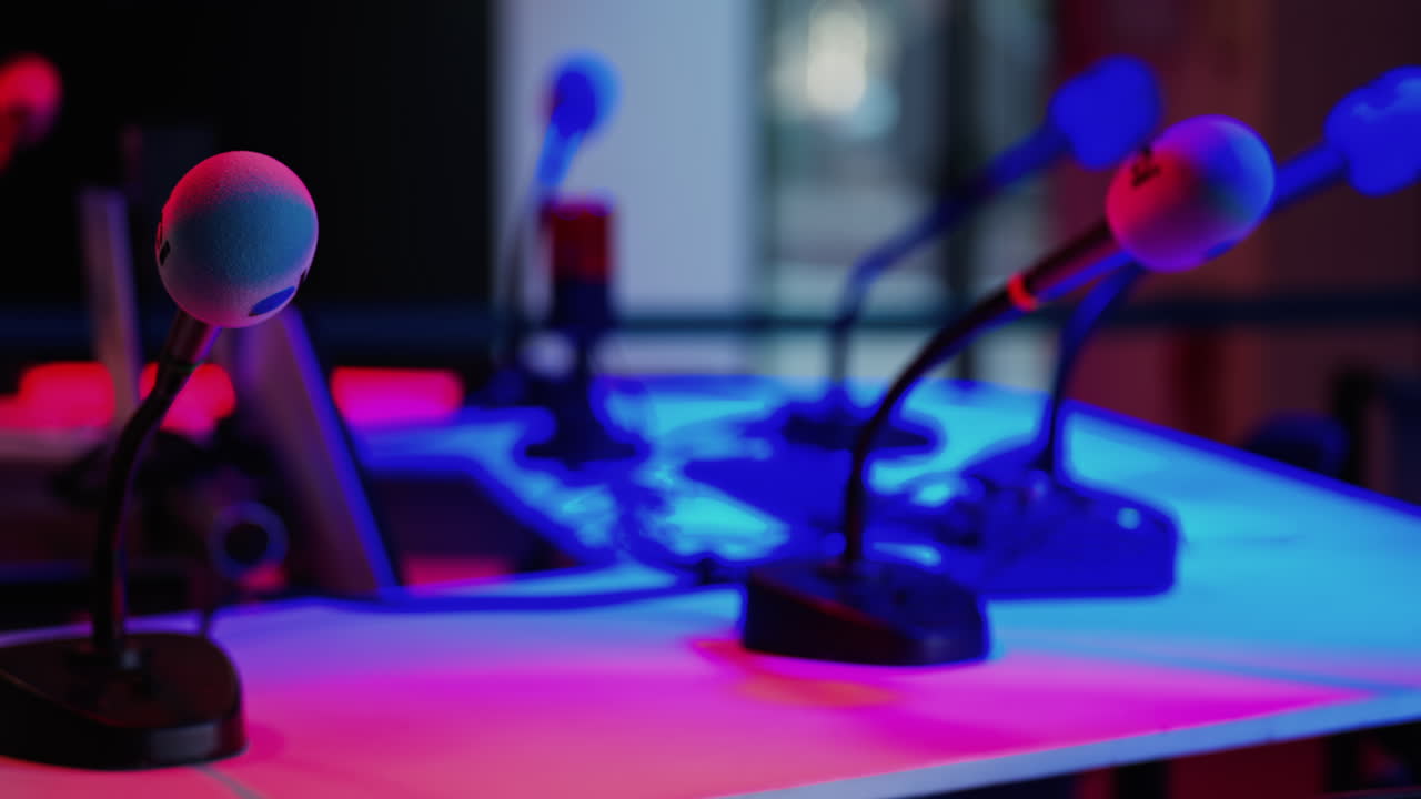 Cannes, France - March 2, 2025: Close up of a microphone on a blurred background with blue and red lights at the International Games Festival