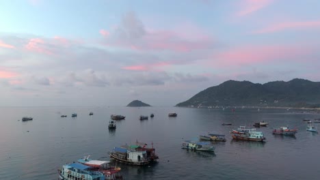 sunset over the sea with boats