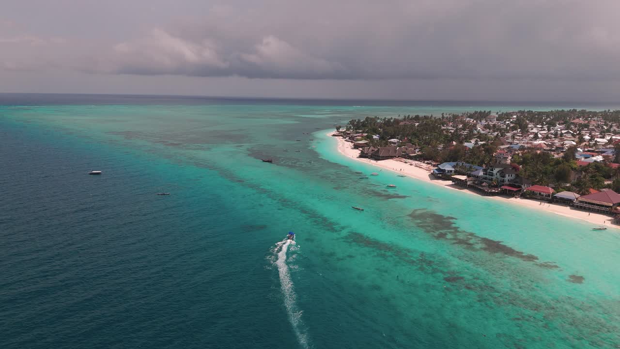 Motorboat Leaving Wake In The Surface Of Blue Sea in Nungwi, Zanzibar, Tanzania. - aerial shot