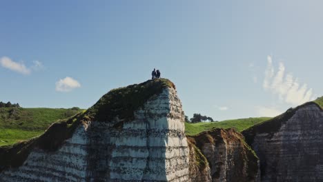 people standing on top of a cliff