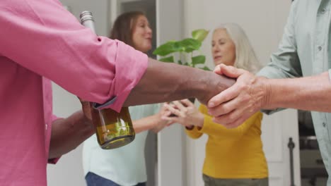 animation of midsection of diverse male senior friends shaking hands