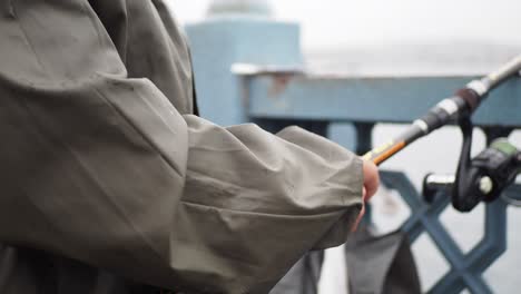 fisherman casting a line from a bridge