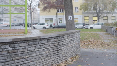 handheld shot of male jumping over wall with parkour move in 4k