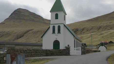 wide tilt down of a church in gjogv, faroe islands