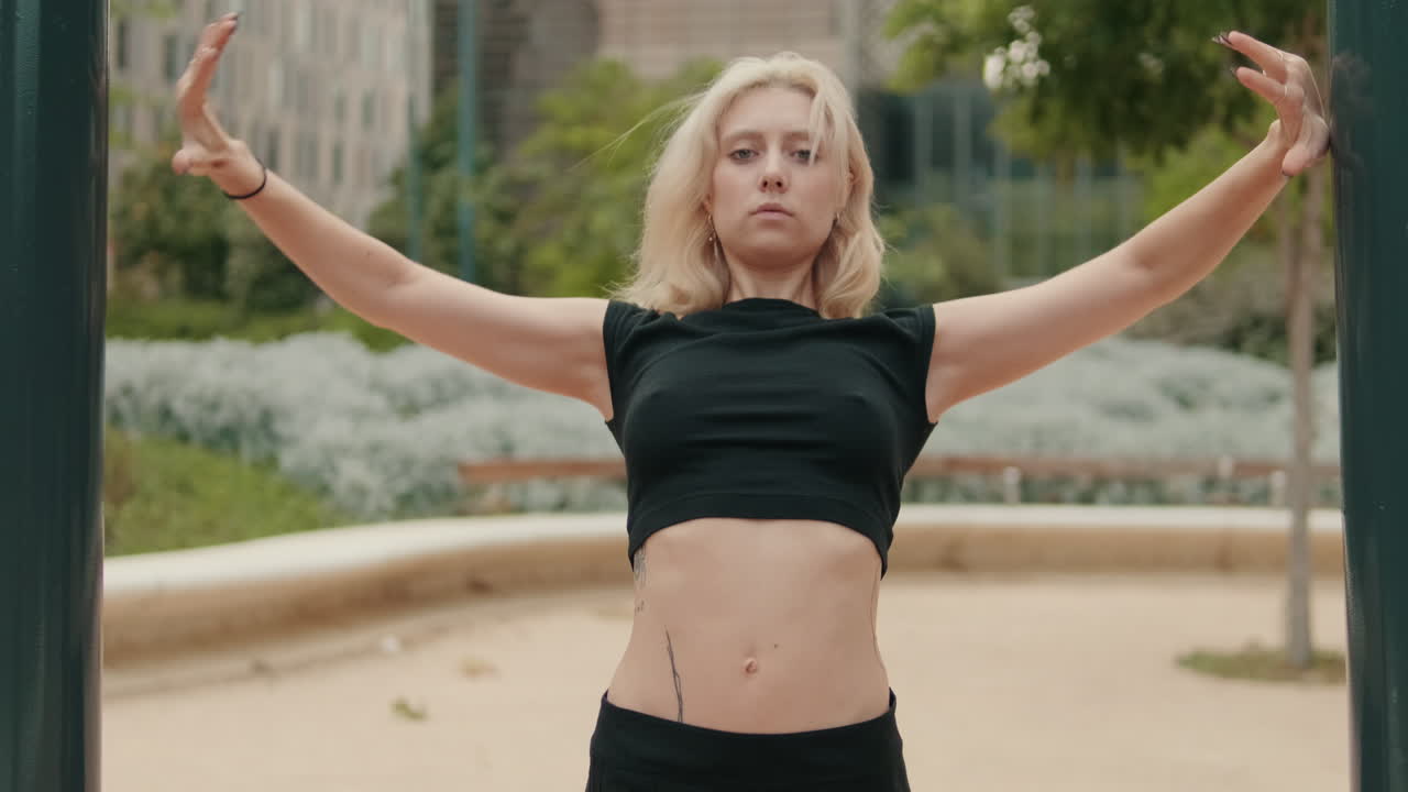Young Blonde Woman Stretching and Exercising in an Urban Park