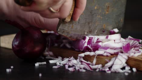 male hands slicing onion big old knife.