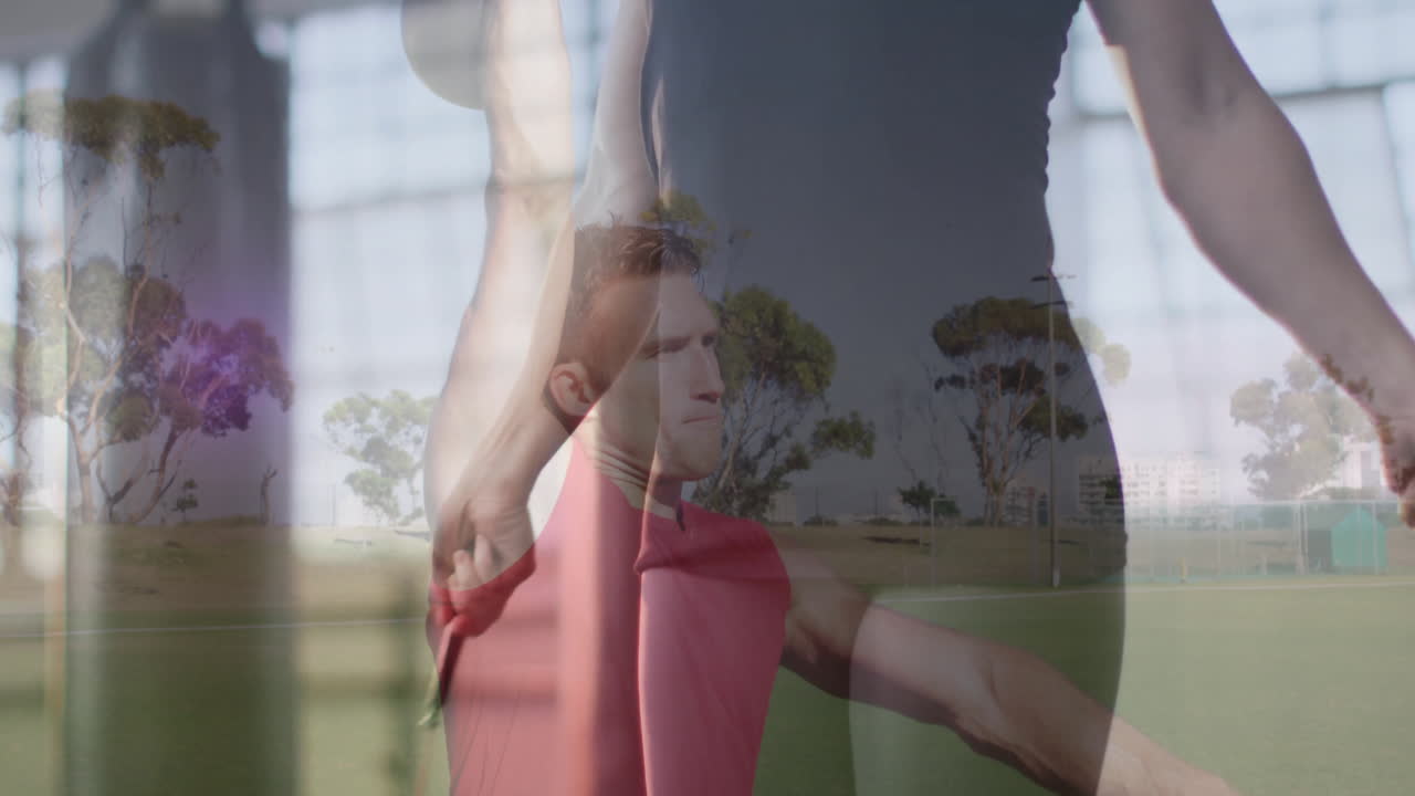 Practicing outdoors, athlete with animation overlay of person stretching in gym