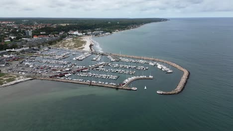 Small-harbor-with-many-boats-on-the-sea,-baltic-sea,-helsingor,-denmark,-europe,-drone