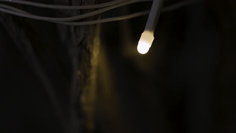 a single glowing light bulb in the dark