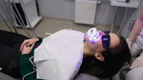 dentist treats oral cavity. young female patient visiting dentist office