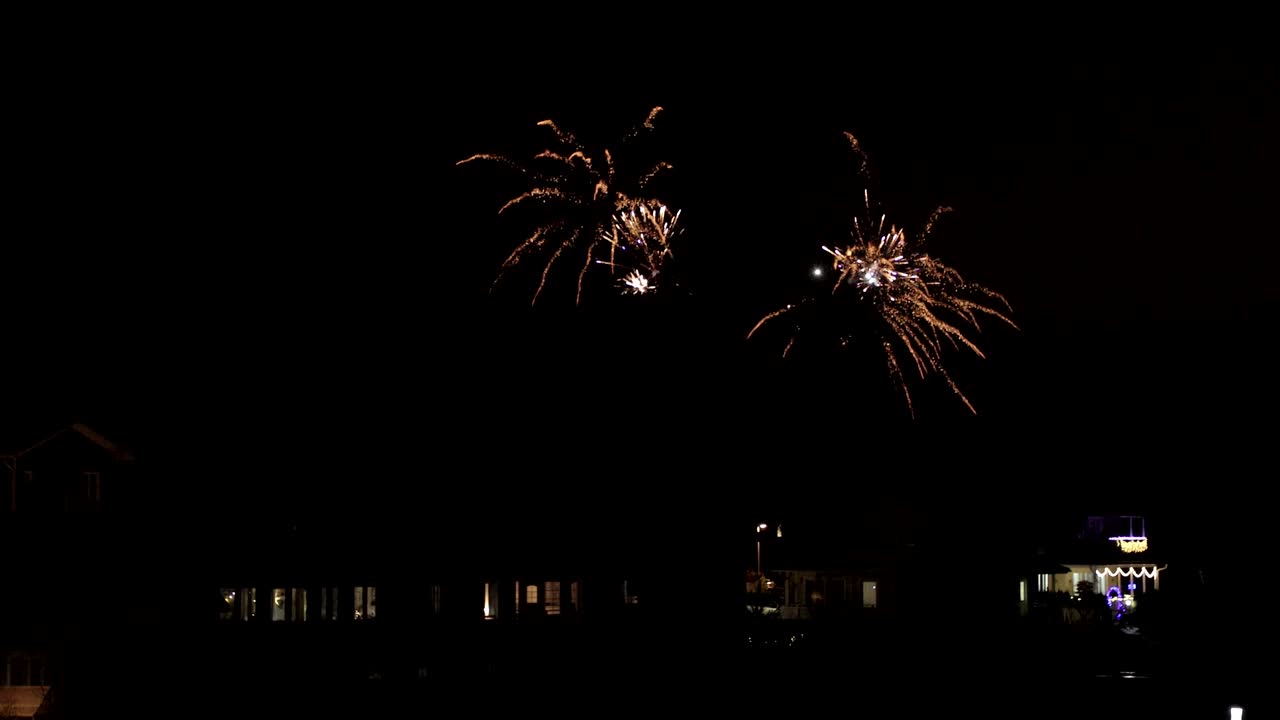 fuegos artificiales en el cielo nocturno sobre las casas
