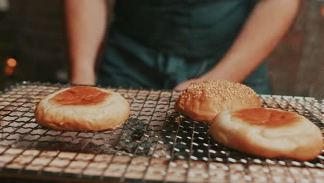 frying burger buns on hot smoky outdoor grill