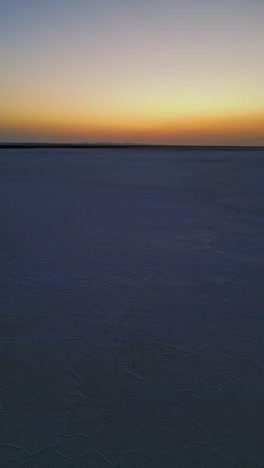 a panning aerial view of the rann of kutch gujrat india reveals the endless white salt desert glowing softly as the sunrise paints the landscape in warm golden hues 4k