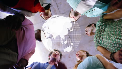 animation of globe over work colleagues stacking hands in background