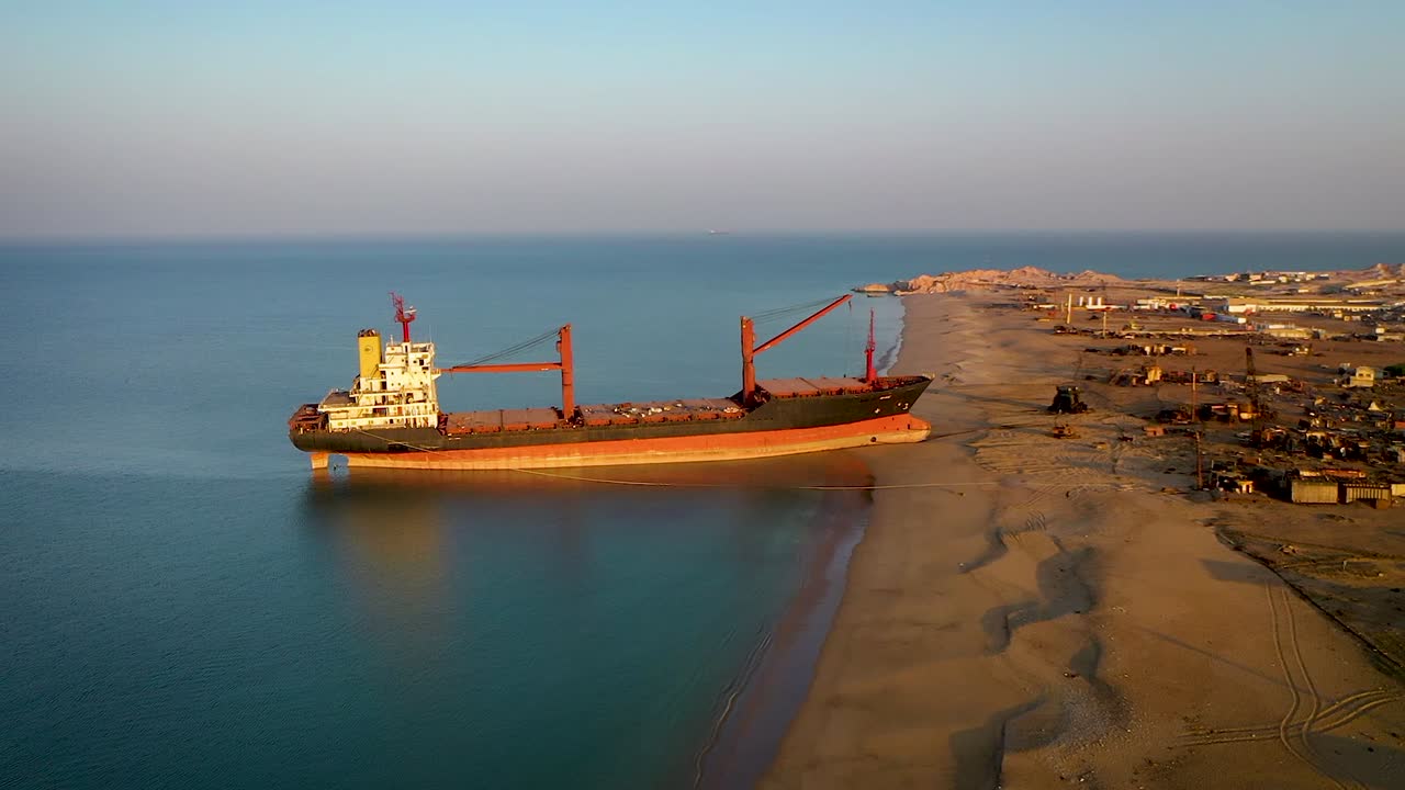 Cargo ship that carries containers docked on beach port for repairs.