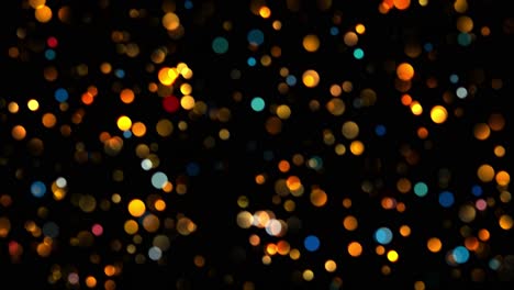 animation of small round blue and orange particles in bokeh