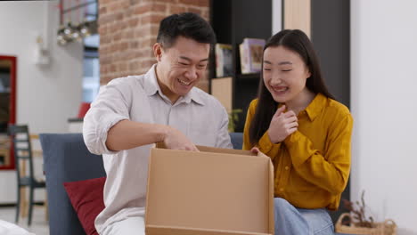 excited couple unboxing a gift