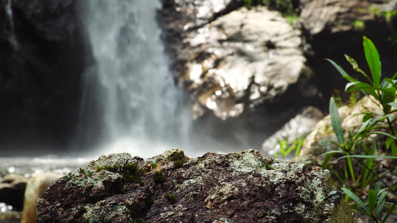 Close up on rock with rapidly falling from steep cliff of TaGu Waterfall Vietnam
