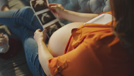 pregnant woman viewing ultrasound photos