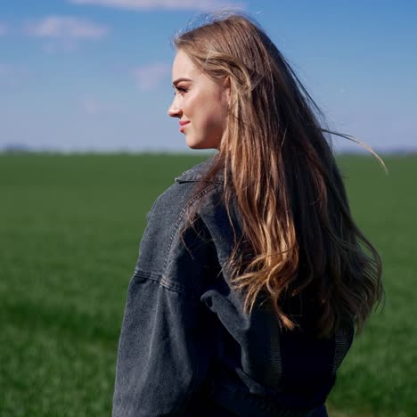 woman enjoying nature in field. young girl happily walking in slow motion through field