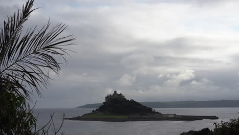 view from a terrace in marazion of the english medieval castle and church of st michael's mount in cornwall on a cloudy spring day