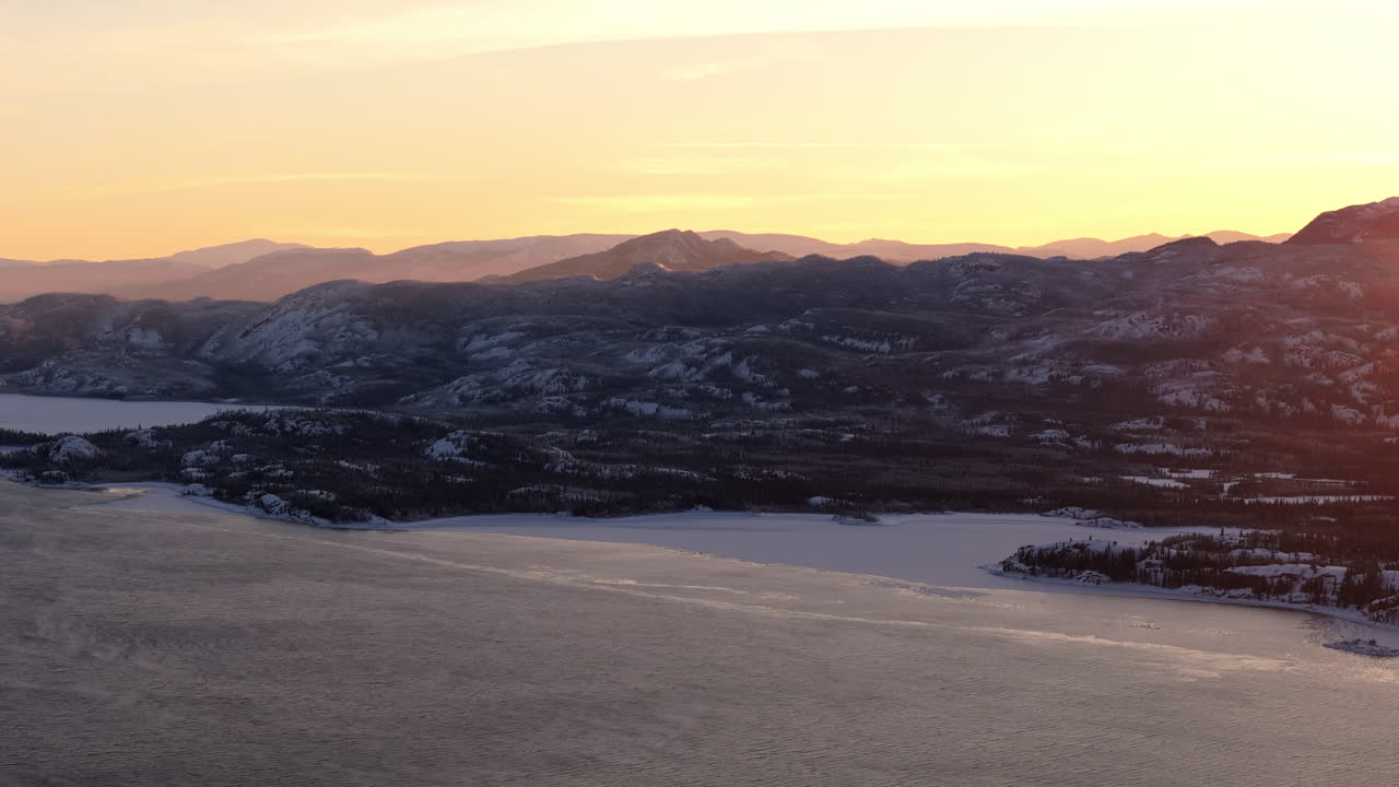 Aerial View Of Frozen Lake Laberge At Sunrise In Whitehorse, Yukon in Canada.