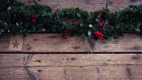 Animation-of-christmas-decoration-with-snow-falling-on-wooden-boards