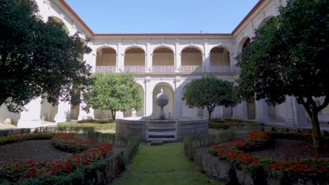 a cloister garden inside a portuguese monastery, called 'santa mafalda de arouca monastery,' featuring a stone monument , situated in arouca