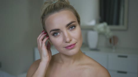 Beautiful-woman-adjusting-hair-in-bathroom