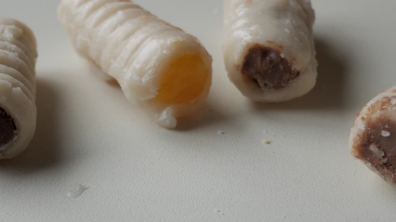 Close up and panning right shot Huesos de Santo sweets. Traditional from Spain.